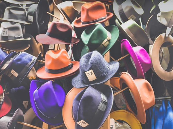 multicoloured fedora hats on a rack